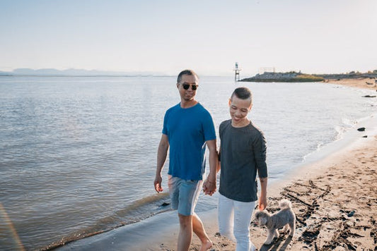Dad walking with son on the beach