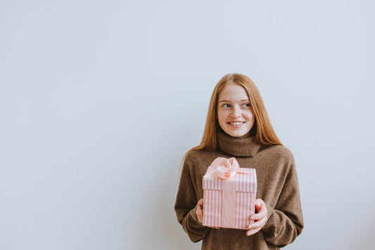Young woman holding a gift box