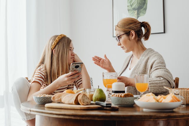 Mom and daughter arguing at kitchen table