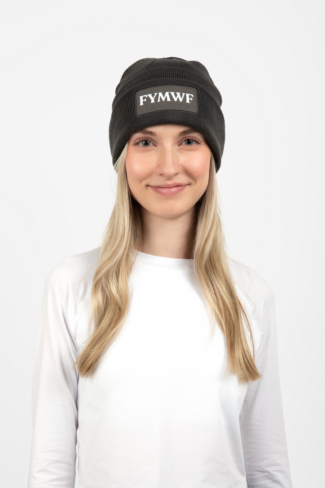 Woman wearing dark gray beanie with FYMWF logo