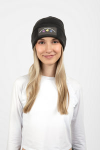 Woman wearing dark gray beanie with Fill Your Mind With Flowers on the front