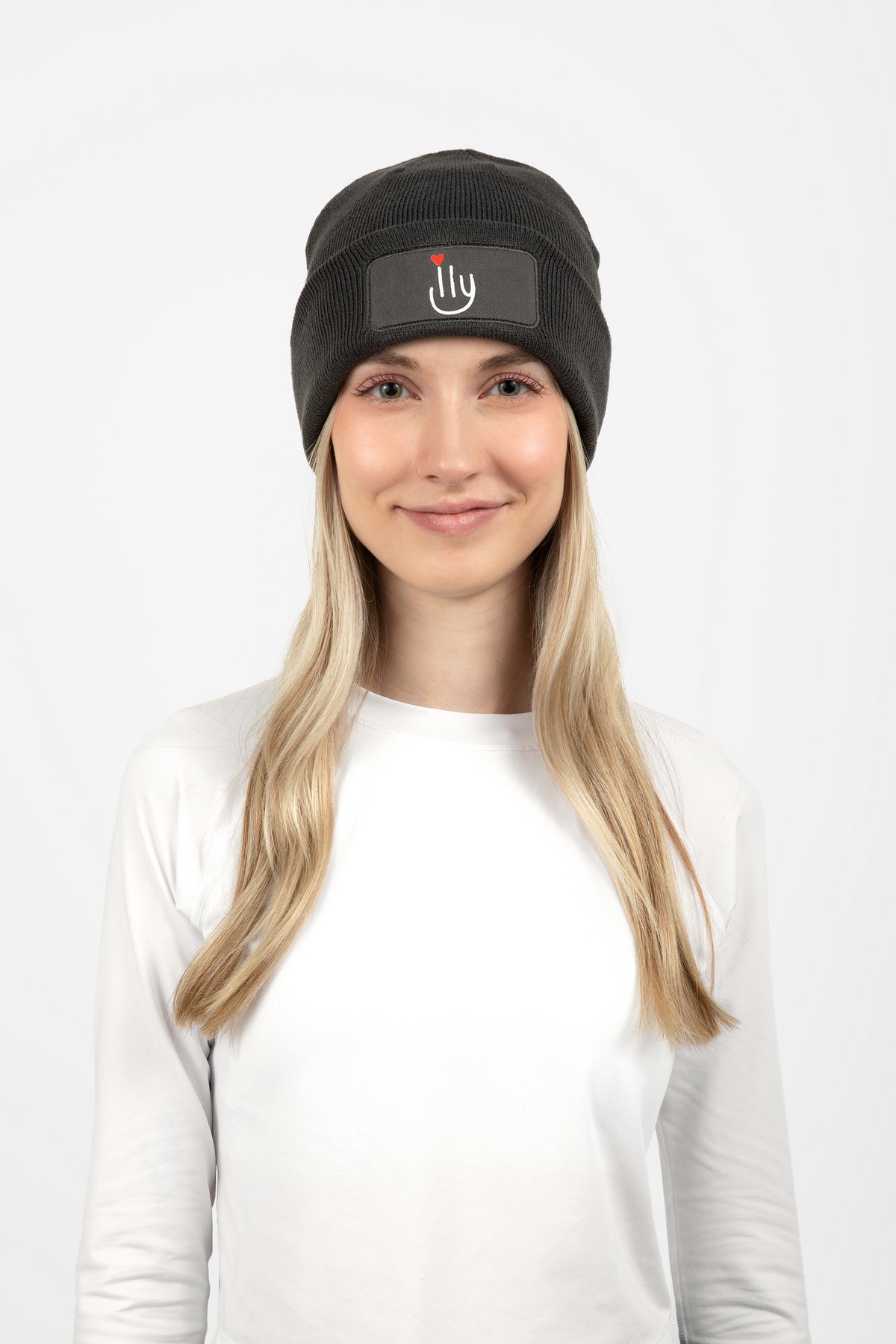 Woman wearing dark gray beanie with ILY logo on the front