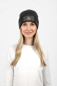Woman wearing dark gray beanie with ILY logo on the front