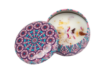 Purple decorative candle tin that includes dried flowers in the soy wax