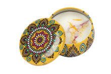 Yellow decorative candle tin that includes dried flowers in the soy wax
